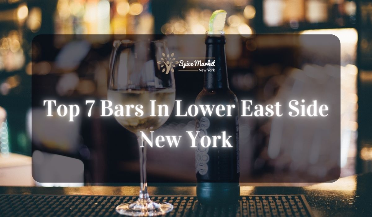 Top 7 Bars In Lower East Side New York - a bar with good lighting, a bottle and glass of alcohol on a table