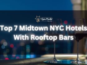 Top 7 Midtown NYC Hotels With Rooftop Bars - a rooftop bar with a table and 2 glasses of wine and a beautiful city lights view
