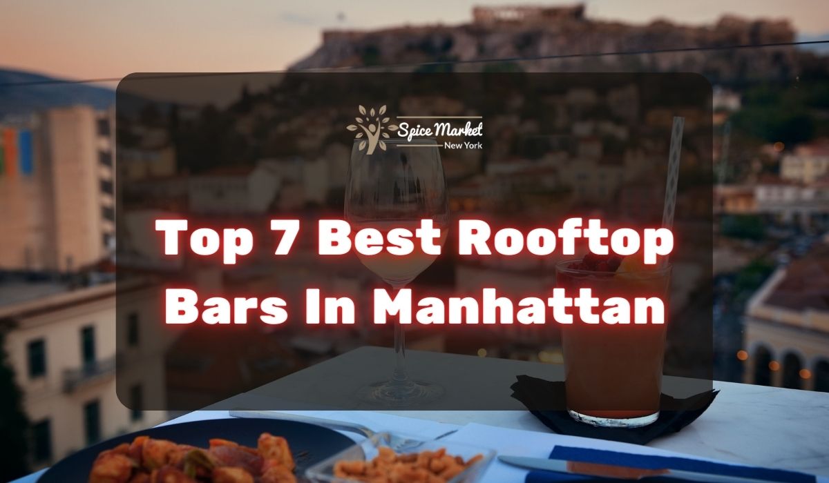 Top 7 Best Rooftop Bars In Manhattan NYC - food and cocktails on a table with a nice view from a rooftop bar
